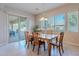 Dining area with sliding door to backyard access, wood table and chairs at 2952 E Warbler Rd, Gilbert, AZ 85297