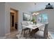 Elegant dining room boasts modern chandelier, stylish table setting, and natural light from window at 2952 E Warbler Rd, Gilbert, AZ 85297