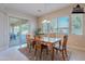 Bright dining room with wooden table set, sliding glass door to patio, and a neutral color scheme at 2952 E Warbler Rd, Gilbert, AZ 85297