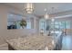 Large kitchen island with granite countertops and pendant lighting at 2952 E Warbler Rd, Gilbert, AZ 85297