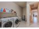 Convenient laundry room with washer, dryer, and utility sink at 2952 E Warbler Rd, Gilbert, AZ 85297