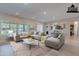 Spacious living room with large sectional sofa, modern coffee table, and bright natural light at 2952 E Warbler Rd, Gilbert, AZ 85297