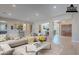 Open-concept living room showcases a comfortable sectional sofa, modern decor, and seamless flow to the kitchen at 2952 E Warbler Rd, Gilbert, AZ 85297