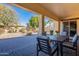 Large covered patio, with table and chairs, overlooking the backyard at 2952 E Warbler Rd, Gilbert, AZ 85297