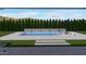 An outdoor pool features a stone retaining wall with sheer descents, lounge chairs and an umbrella for shade at 2952 E Warbler Rd, Gilbert, AZ 85297