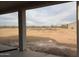 View from patio of expansive backyard with desert landscape and potential for customization at 29577 N 220Th Ave, Wittmann, AZ 85361