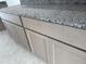 Close up of gray wood cabinets and granite countertop at 29577 N 220Th Ave, Wittmann, AZ 85361