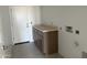 Bright laundry room featuring tile flooring, storage cabinets, and utility connections at 29577 N 220Th Ave, Wittmann, AZ 85361