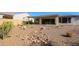 Desert landscaping with a covered patio and a rock dry creek bed at 3020 N 165Th Ave, Goodyear, AZ 85395