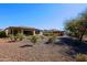 Landscaped backyard with gravel and desert plants at 3020 N 165Th Ave, Goodyear, AZ 85395