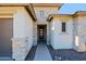 Front entry with stone accents and modern door at 3020 N 165Th Ave, Goodyear, AZ 85395