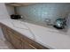 Kitchen boasts expansive quartz countertops and stylish backsplash at 3020 N 165Th Ave, Goodyear, AZ 85395