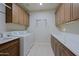 Bright laundry room with washer, dryer, ample cabinets, and quartz countertops at 3020 N 165Th Ave, Goodyear, AZ 85395