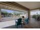 Relaxing covered patio with teal chairs and backyard view at 3020 N 165Th Ave, Goodyear, AZ 85395