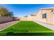 Artificial turf and gravel backyard with block wall at 30358 N Juniper Dr, Florence, AZ 85132