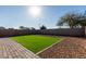 Artificial turf and gravel backyard with brick pathway at 30358 N Juniper Dr, Florence, AZ 85132