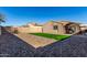 Landscaped backyard with artificial turf and gravel at 30358 N Juniper Dr, Florence, AZ 85132