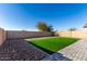 Landscaped backyard with artificial turf and a block wall at 30358 N Juniper Dr, Florence, AZ 85132