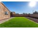 Artificial turf and gravel backyard with brick pathway at 30358 N Juniper Dr, Florence, AZ 85132