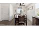 Dining room with a large wooden table and chairs, ceiling fan, and decorative wall art at 30358 N Juniper Dr, Florence, AZ 85132