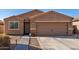 Single-story house with a two-car garage and a paved walkway at 30358 N Juniper Dr, Florence, AZ 85132