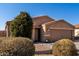 Tan house with brown garage door and landscaping at 30358 N Juniper Dr, Florence, AZ 85132