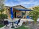 Spacious backyard patio with seating area, umbrella, and fire pit at 31655 N 131St Ave, Peoria, AZ 85383