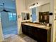 Main bathroom with double sinks, granite countertops, and a view of the bedroom at 31655 N 131St Ave, Peoria, AZ 85383