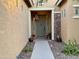 Inviting entryway with a light-grey door, stone accents, and desert landscaping at 31655 N 131St Ave, Peoria, AZ 85383