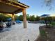 Covered patio with seating, retractable awning, and fire pit at 31655 N 131St Ave, Peoria, AZ 85383