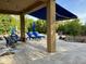 Covered patio with seating, retractable awning, and fire pit at 31655 N 131St Ave, Peoria, AZ 85383