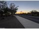 Residential street at sunset, with sidewalk and landscaping at 31655 N 131St Ave, Peoria, AZ 85383