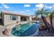 Inviting kidney-shaped pool with a spacious patio and lush landscaping at 3383 E Santa Fe Ln, Gilbert, AZ 85297