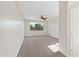 Spacious bedroom with carpet flooring, ceiling fan, and a window offering natural light and neighborhood views at 3383 E Santa Fe Ln, Gilbert, AZ 85297