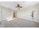 Large bedroom with carpet flooring, ceiling fan, and access to a private outdoor area at 3383 E Santa Fe Ln, Gilbert, AZ 85297