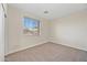 A bright bedroom featuring neutral carpet, a window, and a closet door at 3383 E Santa Fe Ln, Gilbert, AZ 85297