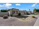 Property front view, showcasing a tan house with stone accents at 3383 E Santa Fe Ln, Gilbert, AZ 85297