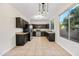 Charming eat-in kitchen with dark cabinets, stainless steel appliances, and modern light fixture at 3383 E Santa Fe Ln, Gilbert, AZ 85297