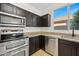 Close up on bright kitchen featuring stainless steel appliances, granite countertops, and ample cabinet space at 3383 E Santa Fe Ln, Gilbert, AZ 85297