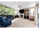 Living room with fireplace, large TV, and sectional sofa at 3383 E Santa Fe Ln, Gilbert, AZ 85297