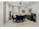 Elegant dining room with a modern chandelier and blue velvet chairs at 34150 W Corleone Dr, Maricopa, AZ 85138