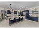 Modern kitchen features navy cabinetry, marble backsplash, and stainless steel appliances at 34150 W Corleone Dr, Maricopa, AZ 85138