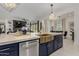 Stylish kitchen island with a farmhouse sink and modern gold fixtures at 34150 W Corleone Dr, Maricopa, AZ 85138