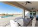 Relaxing patio with outdoor furniture and pool view at 34150 W Corleone Dr, Maricopa, AZ 85138