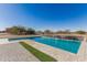 Inviting pool with a waterfall feature and spacious patio at 34150 W Corleone Dr, Maricopa, AZ 85138