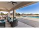 Covered patio overlooking a refreshing pool at 34150 W Corleone Dr, Maricopa, AZ 85138