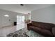 Living room with tiled floors, brown couch, and view into dining area and patio at 3416 N 44Th St # 35, Phoenix, AZ 85018