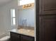 Bathroom vanity with dark brown cabinets and a large mirror at 38007 W Mcdowell Rd, Tonopah, AZ 85354