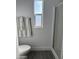 Bathroom with toilet, shower, and gray flooring at 38007 W Mcdowell Rd, Tonopah, AZ 85354