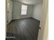 Bright bedroom with grey vinyl flooring and large window at 38007 W Mcdowell Rd, Tonopah, AZ 85354